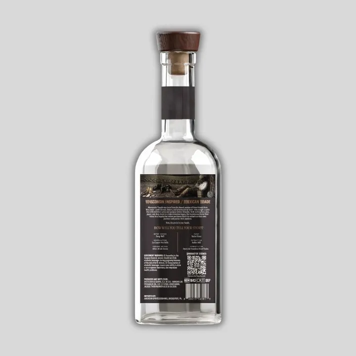 The back of the Chapter Two bottle, rendered on a gray ground, with the back label’s engraved strip, the brand story and the production details